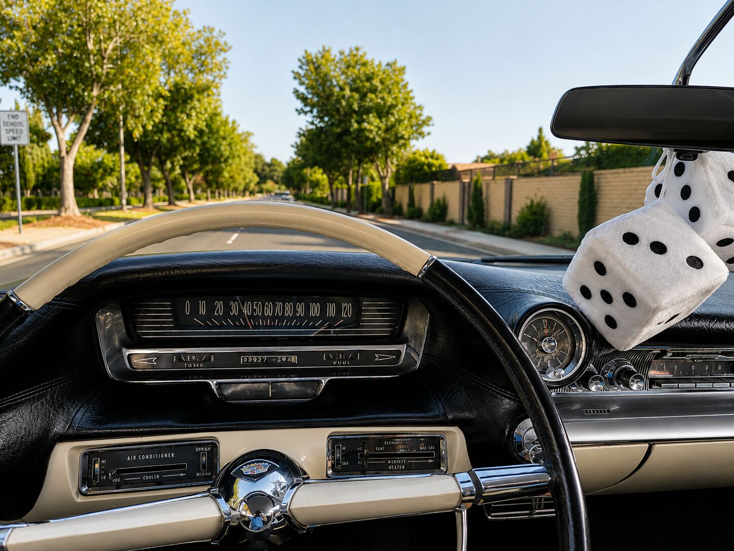 Driver's view over a classic Cadillac dashboard on the open road