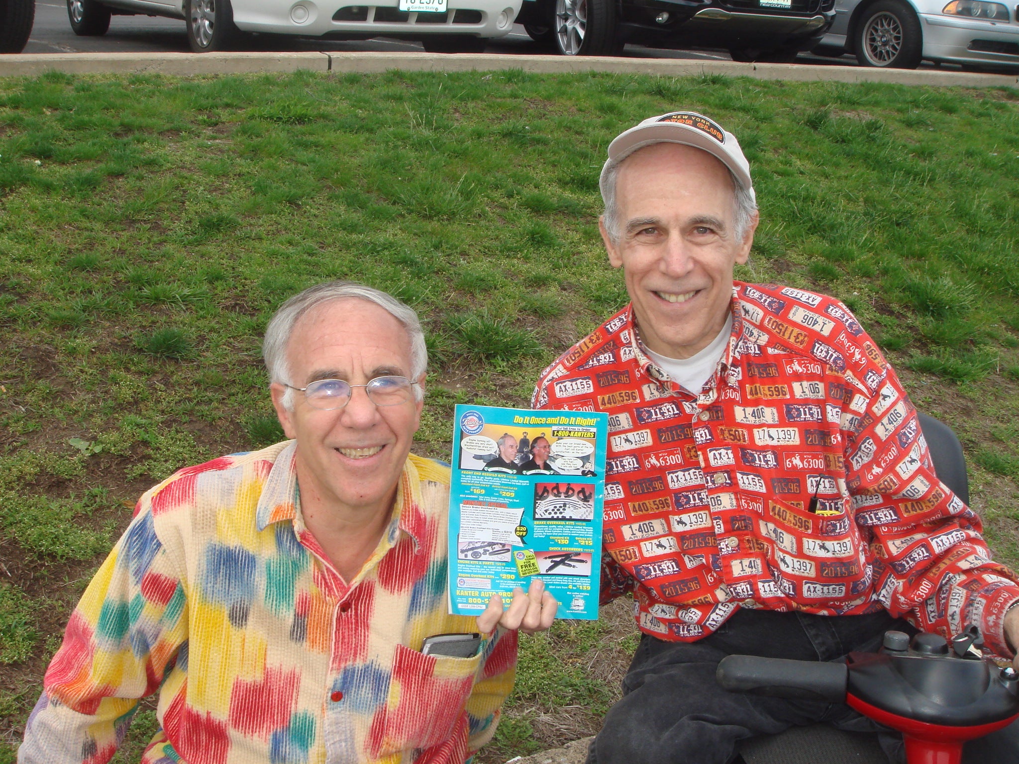 Fred and Dan Kanter holding a Kanter Auto Products catalog